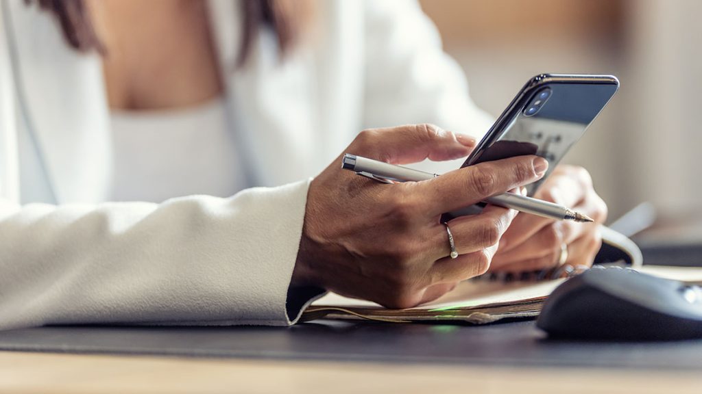 Why Choose a Progressive Web App for Your Brand? Business woman using her smart phone